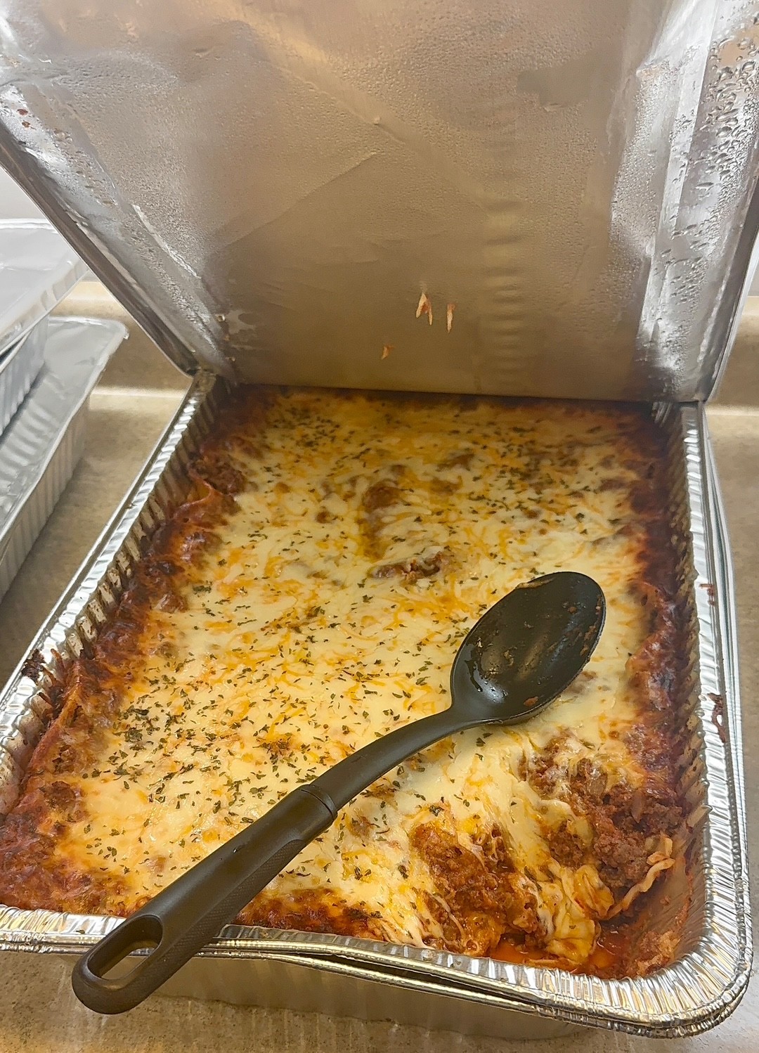Prepared lasagna in a catering pan
