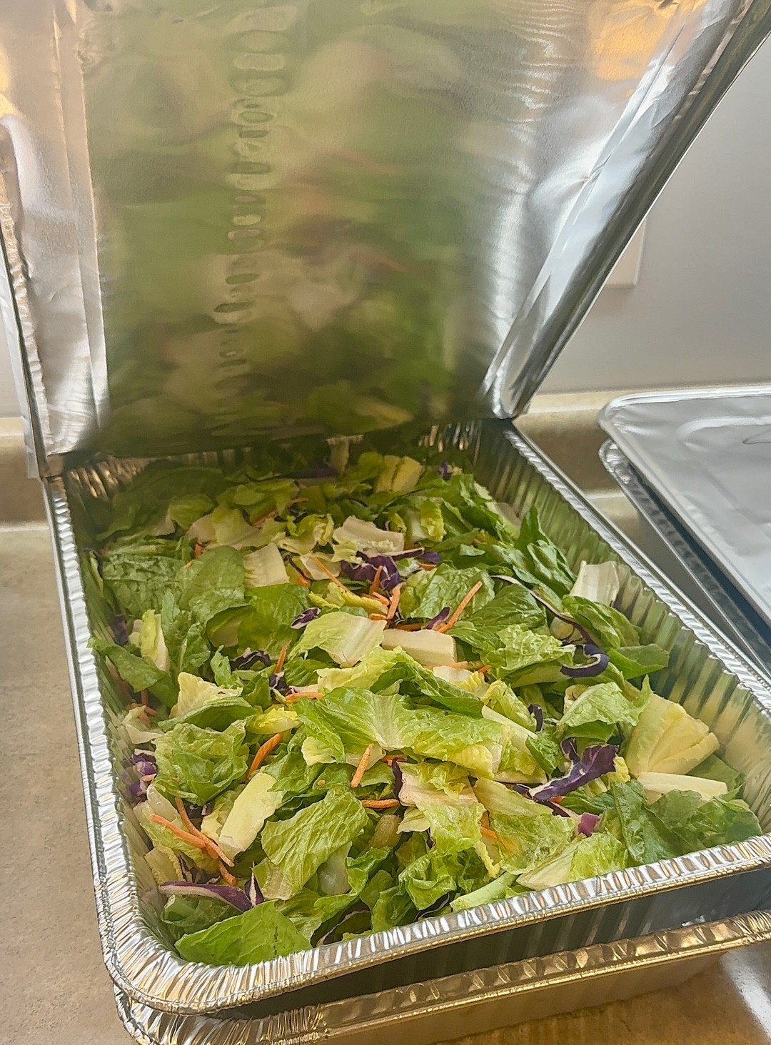 Fresh prepared salad in a catering pan